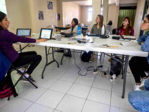 Indigenous women hold an office meeting