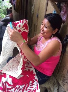 woman showing her embroidery art